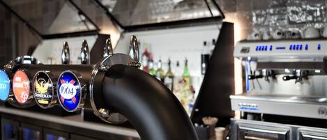 A bar area with a tap and a coffee machine.