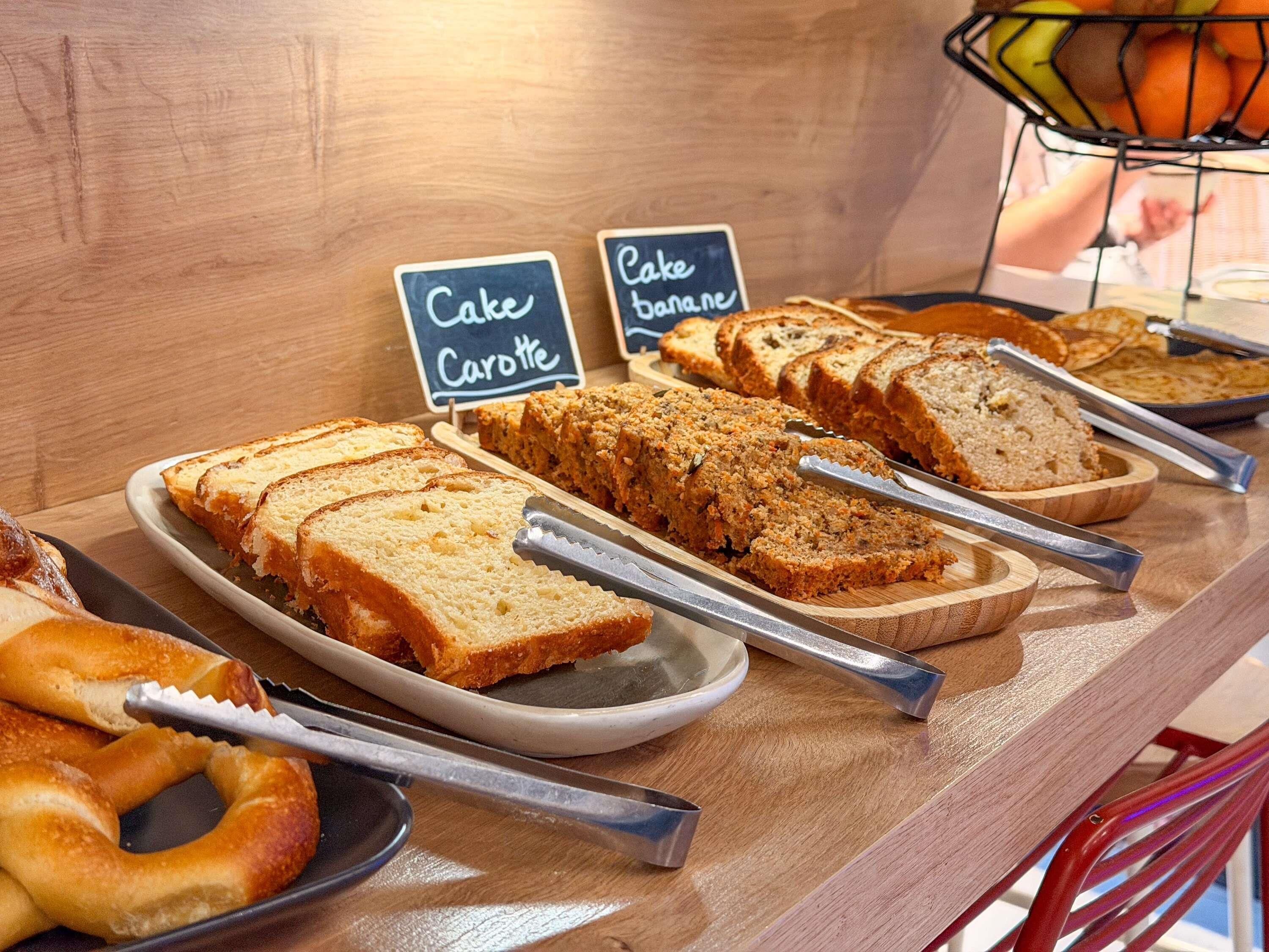 A bakery display with various breads and a sign indicating 'Cake' and 'Carotte'.