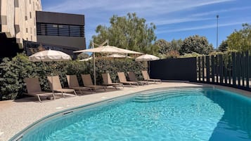 Seasonal outdoor pool, pool umbrellas, pool loungers