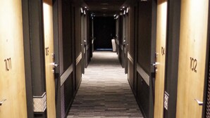 A hotel corridor with doors numbered 101 to 102, carpeted flooring, and recessed lighting. - Ibis Lunel Petite Camargue (Lunel)