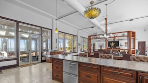 A spacious kitchen with a large island, stainless steel appliances, and wooden cabinetry.
