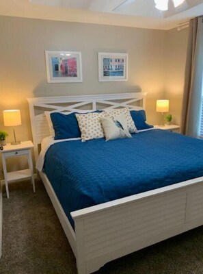 Cozy retreat with a comfortable bed, bedside tables, and lamps.
