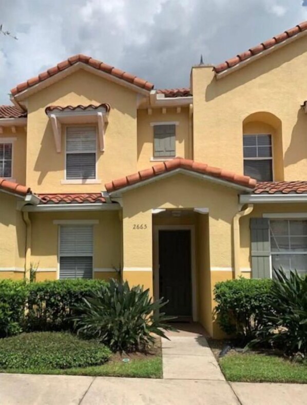 Stunning two-story residence with a charming entrance and beautifully manicured lawn.
