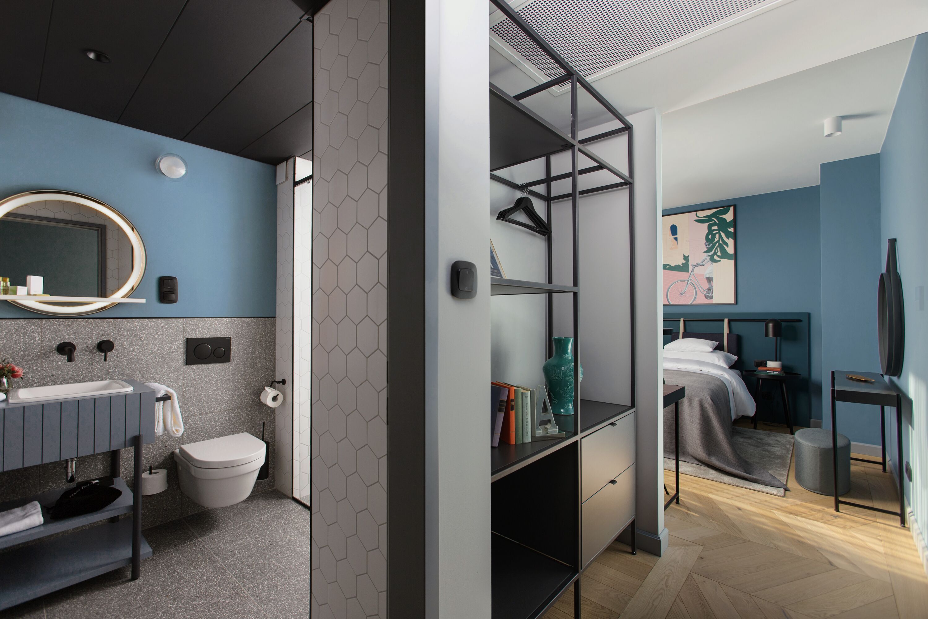 A modern bathroom with a sink, toilet, and mirror.
