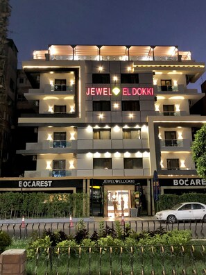 A multi-story building with illuminated signage for 'JEWEL EL DOKKI' and 'BOČAREST'. - Jewel Dokki Hotel (Giza)