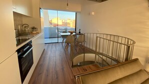 Une cuisine moderne avec un coin repas et un balcon.