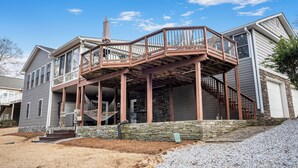 A two-story house with a covered porch and a staircase leading to a second level.