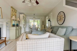 Relax in this inviting space with a comfortable sofa, dining table, and kitchen area.