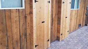 A wooden building with two large doors and a window. - Quiet Old Town Retreat/Pet Friendly
2 King Suites/Beer Tap/EV/AC (Steamboat Springs)