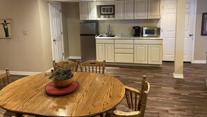 A kitchen with white cabinets, a refrigerator, a microwave, and a sink. - Spacious and Comfortable Garden Level Basement Apartment (Peyton)