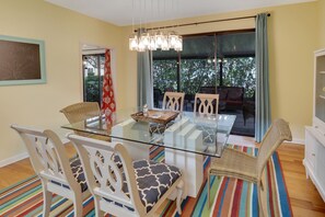 Enjoy meals in this dining area with a glass-top table and comfortable seating.