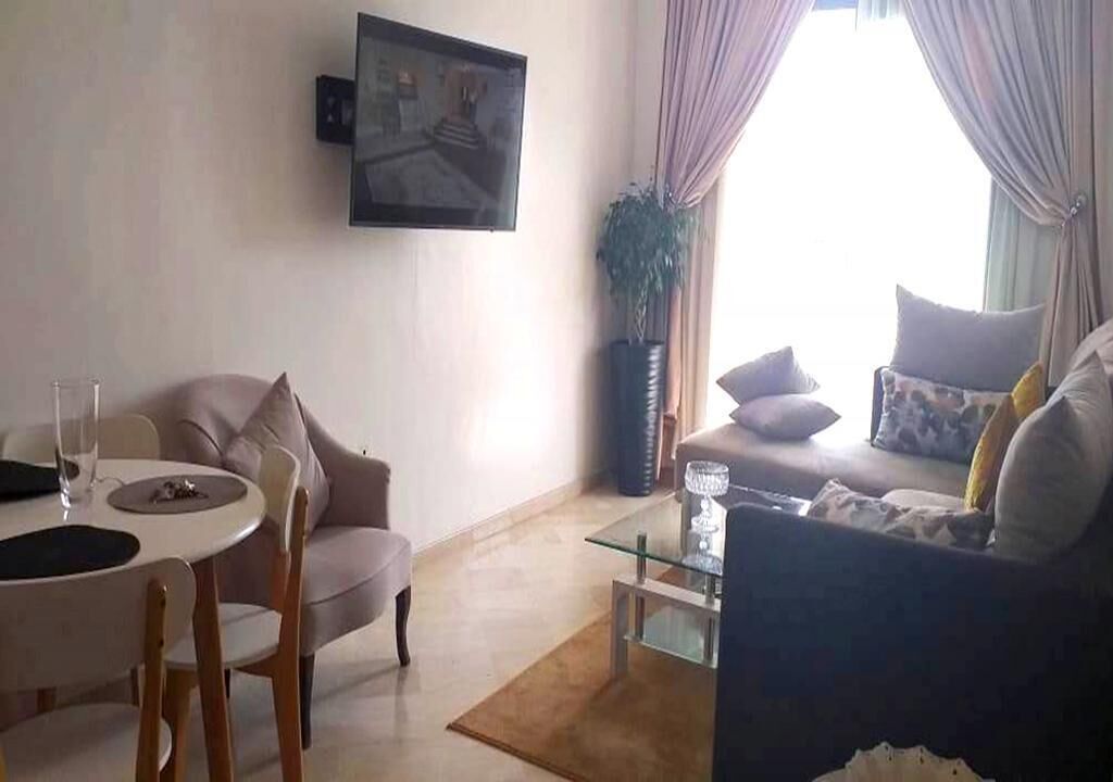 Un salon comprenant un canapé, une table basse et un coin repas avec des chaises et une table.