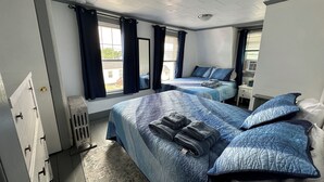 A hotel room with two beds, a desk, and a window with curtains. - Beach Vacation Getaway (Old Orchard Beach)