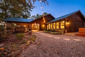 Cozy cabin-style building with a welcoming porch and landscaped garden.