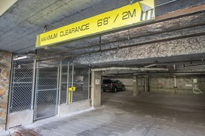 A parking garage with a maximum clearance sign of 68 inches / 2 meters.