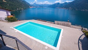 A swimming pool with a view of a lake and mountains. - Residence degli Oleandri 4B (Argegno)