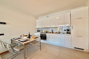 Family Apartment, 2 Bedrooms, Microwave, Mountainside (Residence degli Oleandri 4B) | Private kitchen | Coffee/tea maker, full-size fridge, microwave, oven