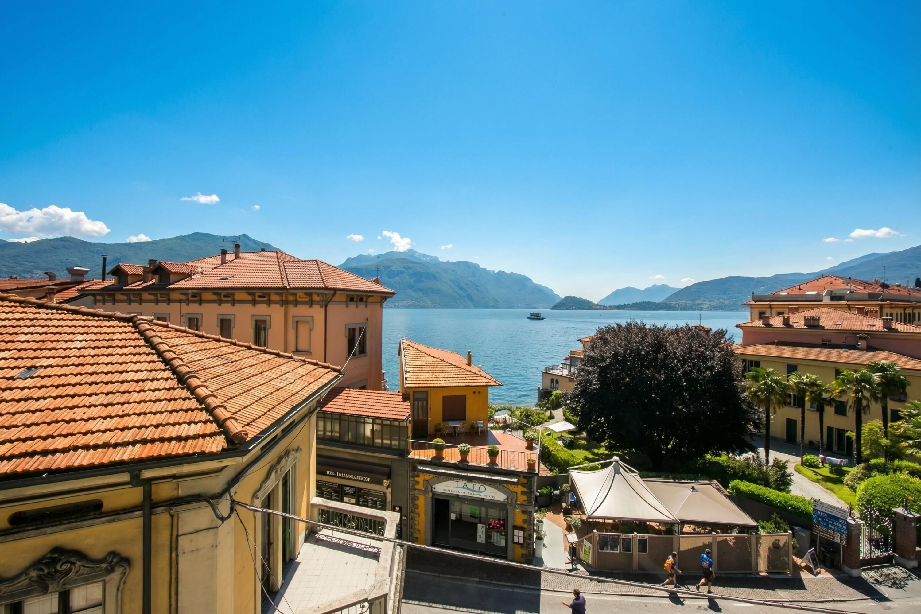 A coastal town with buildings, a clear sky, and a body of water.