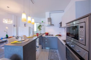 Family Apartment, Multiple Bedrooms, 2 Bathrooms, Mountainside (Como Lake Modern Apartment Ulivi) | Private kitchen | Full-size fridge, microwave, oven, stovetop - Como Lake Modern apartment Ulivi (Tremezzina)