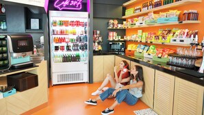 A brightly lit snack bar with a neon sign, a beverage dispenser, and shelves stocked with snacks and drinks. - COSI Krabi Ao Nang Beach (Krabi)