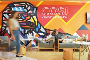 A modern lounge area with colorful wall art, comfortable seating, and a casual atmosphere. - COSI Krabi Ao Nang Beach (Krabi)