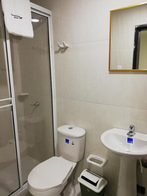 Een douche, handdoeken, zeep, shampoo