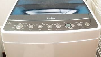 A front view of a white, front-loading washer and dryer unit with a digital control panel displaying various settings and options.