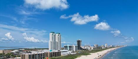 An aerial view showcases the property's incredible location directly along the South Padre Island beach.