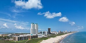 An aerial view showcases the property's incredible location directly along the South Padre Island beach.