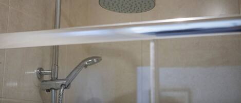A shower with a handheld showerhead and a fixed overhead showerhead.