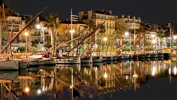 A marina at night with boats docked, buildings in the background, and lights reflecting on the water. - Renovated Bastide, Capelan peninsula, quiet (Bandol)