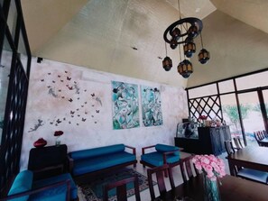 Relax in this serene space with a seating area, dining space, and large window.
