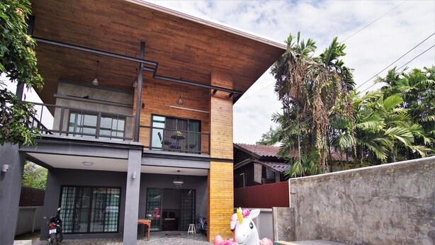 A modern two-story building with a swimming pool, a balcony, and a motorcycle parked outside. - Lan House Pool Villa (Chiang Mai)