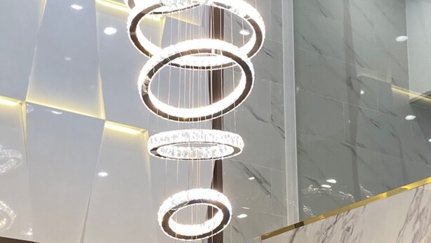 A modern chandelier with multiple circular light fixtures suspended from the ceiling.