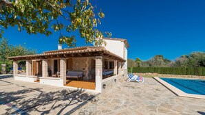 A stone building with a tiled roof, a pool, and outdoor seating. - YESERO. Beautiful villa near Pollensa (Pollensa)