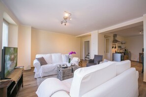 Family Townhome, Multiple Bedrooms, Mountainside (Plesio Rustico Panoramica) | Living area | Flat-screen TV - Plesio Rustico Panoramica (Plesio)