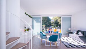 A modern interior with a dining area, staircase, and a sofa. - Casa Laura Apt. 6 (Menaggio)