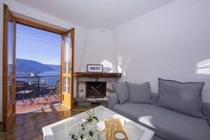 Family Apartment, Multiple Bedrooms, Mountainside (Balcone di Perledo) | Living room | Flat-screen TV, fireplace