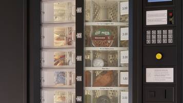 A vending machine with various food items and prices.
