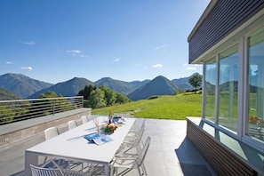A terrace with a table set for dining, overlooking a mountainous landscape. - Villa Intelvi (Cerano d'Intelvi)