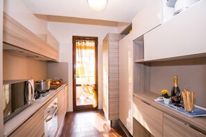 A modern kitchen with a stove, sink, and cabinets.