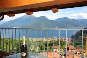 A balcony with a view of a lake and mountains.