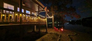 A wooden building with a balcony, string lights, and a flag. - Waterfront house on Weiss Lake (Centre)