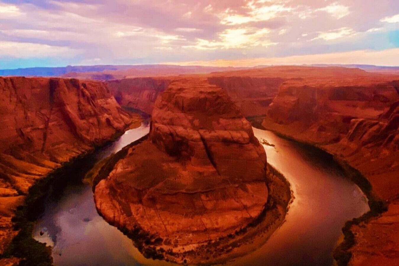 A canyon with a river winding through it.