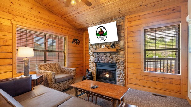 A cozy log cabin interior with a stone fireplace, wooden walls, and a comfortable seating area. - Romantic Walk-in Cabin for Two in the Heart of Branson - Jacuzzi Tub (Branson)