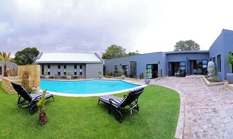 Una piscina al aire libre, sillones reclinables de piscina