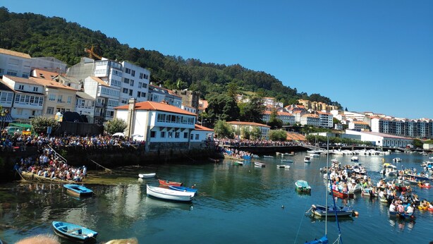 A harbor with boats and a crowd of people.