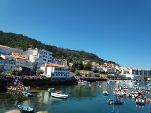 A harbor with boats and a crowd of people.