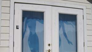 A white door with a glass panel and a brass handle. - Mermaid relaxing studio with Pool (St. Augustine)