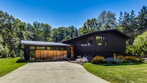 A modern two-story house with a large garage and a well-maintained lawn.